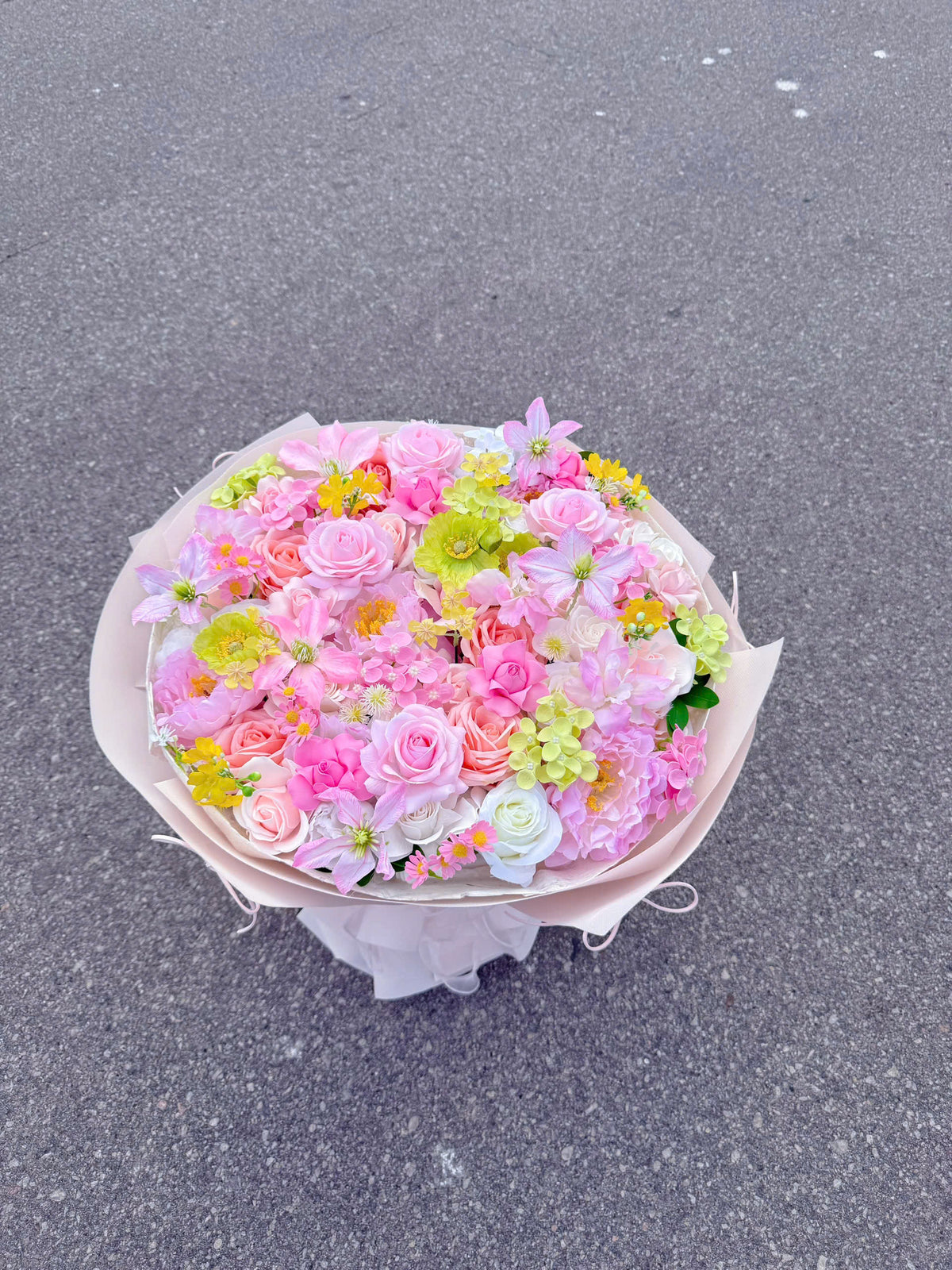 A round-shaped mixed-flower bouquet with a slightly tall, structured base 🌸💐