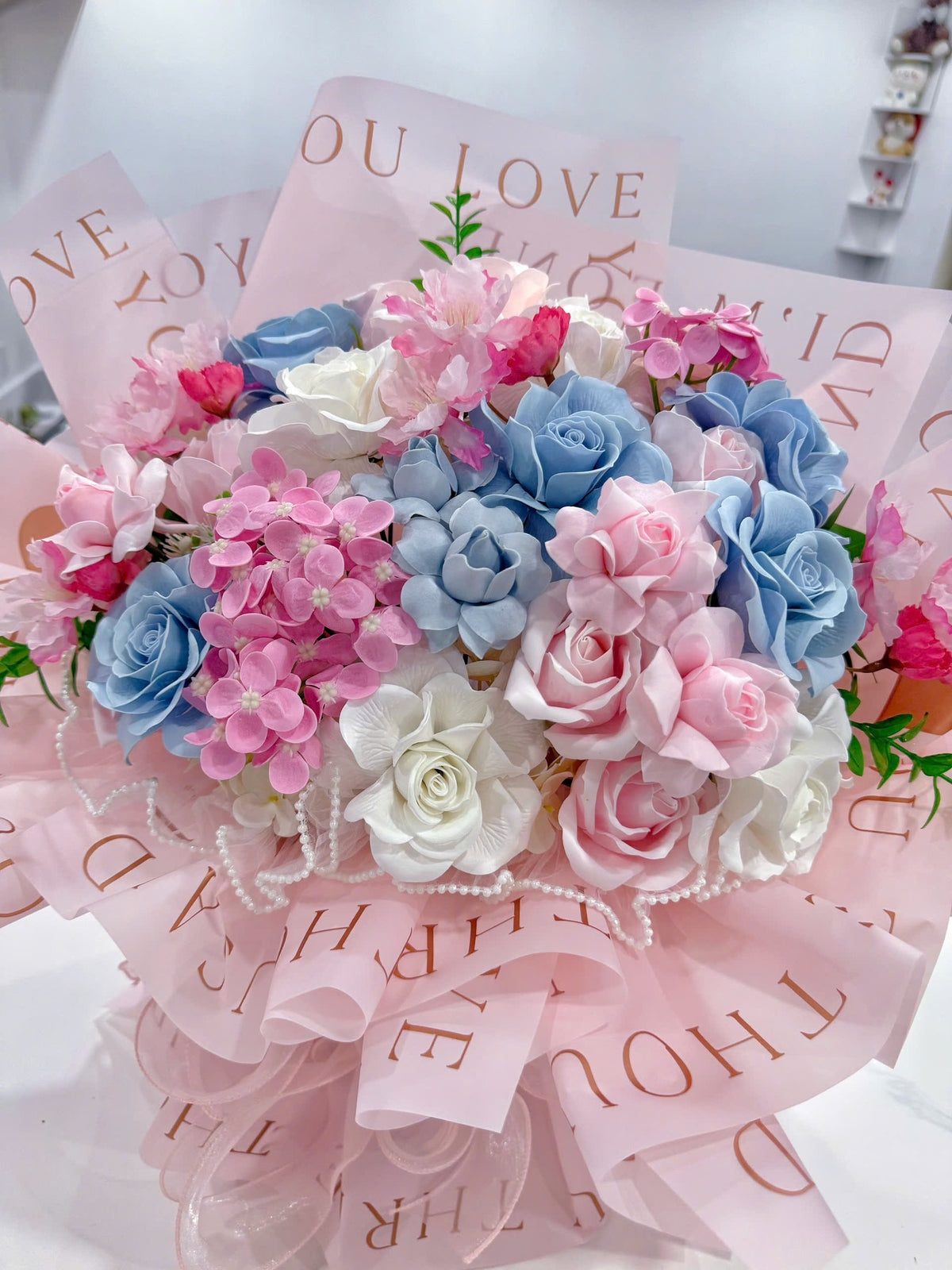 Pink & blue wax flowers in a beautiful fan-shaped arrangement 💗💙💐