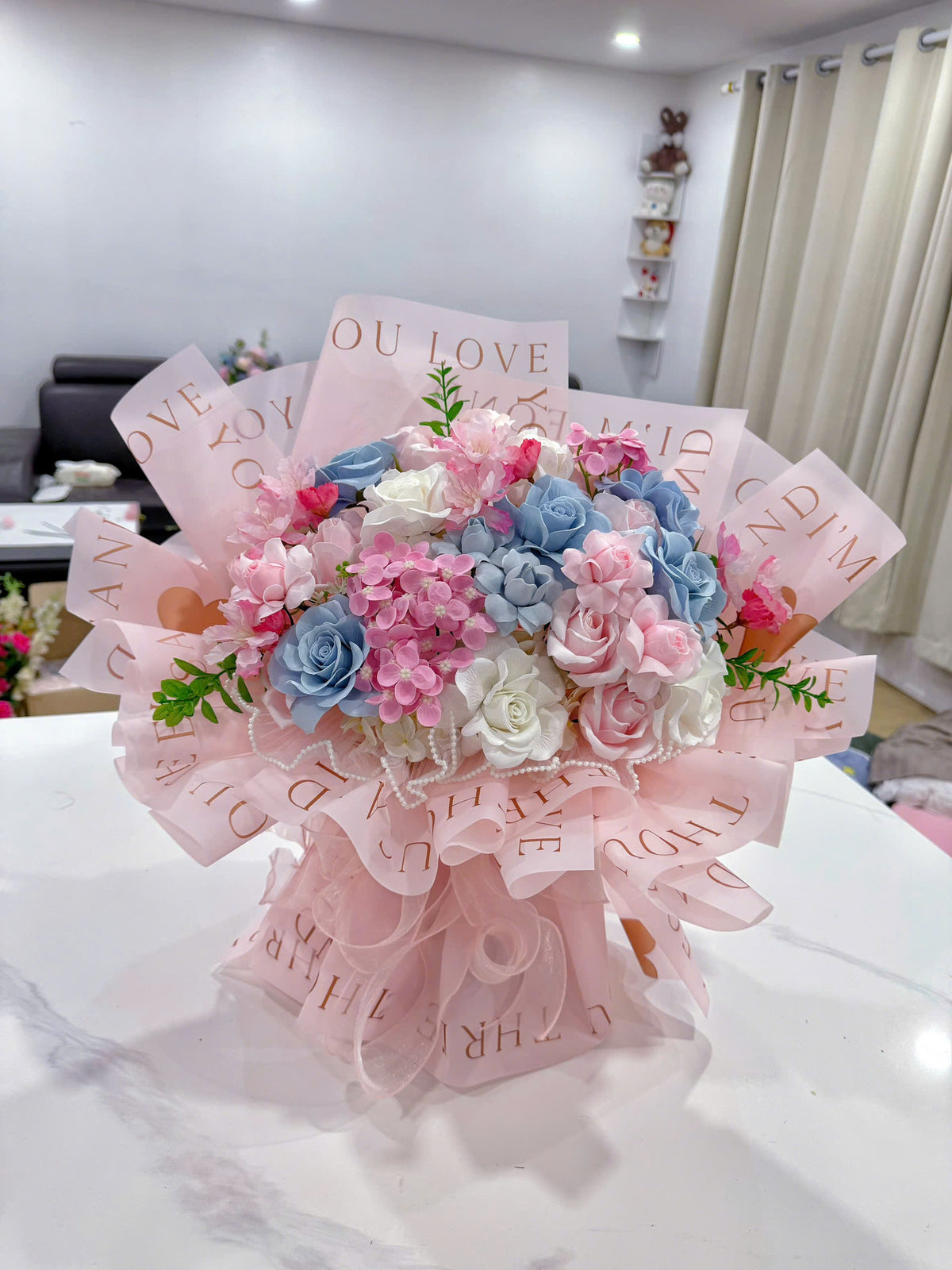 Pink & blue wax flowers in a beautiful fan-shaped arrangement 💗💙💐