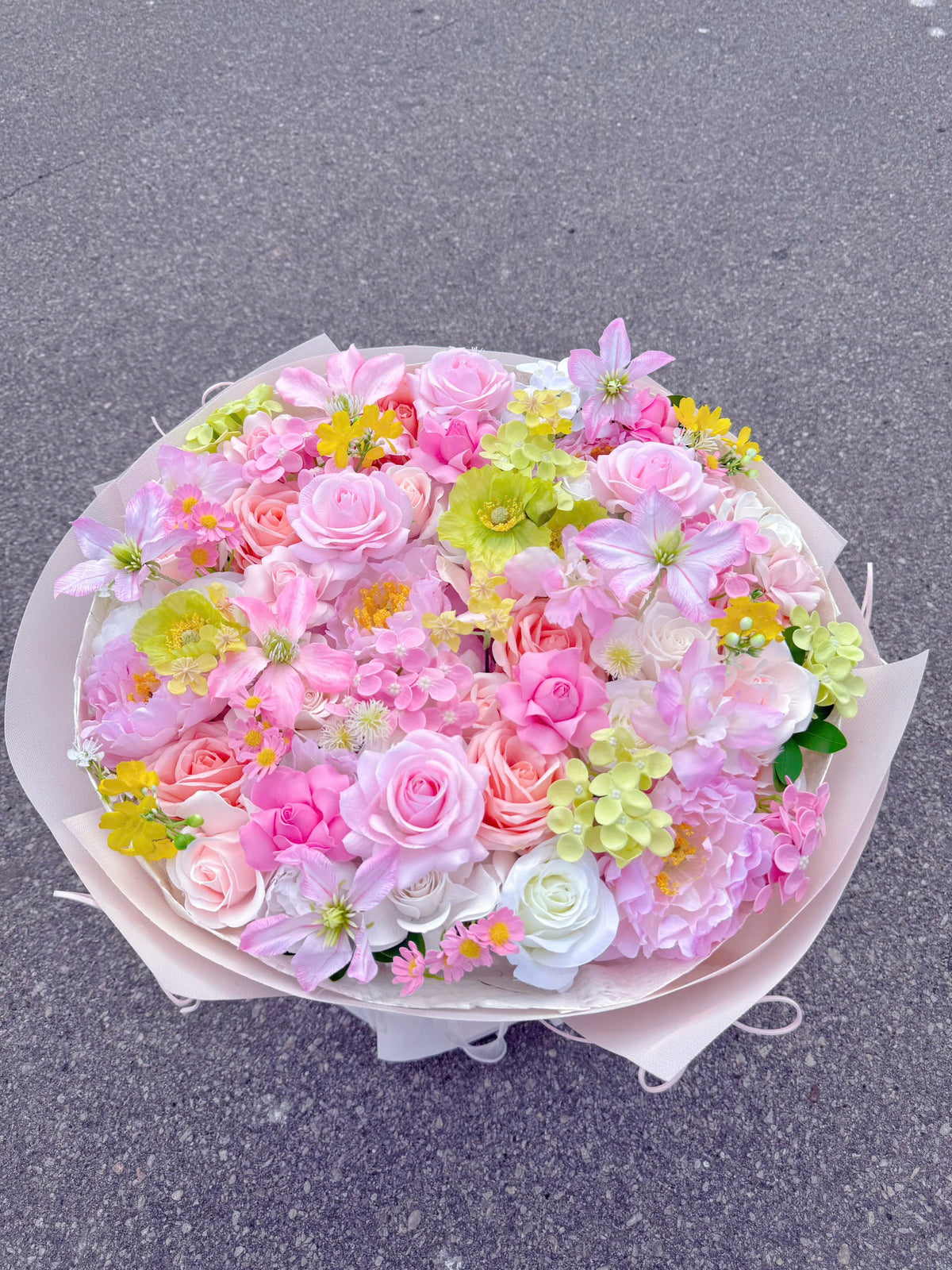 A round-shaped mixed-flower bouquet with a slightly tall, structured base 🌸💐