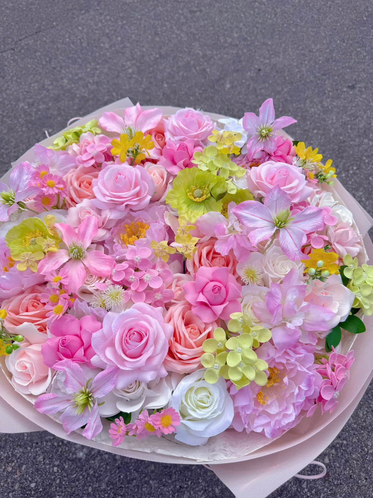 A round-shaped mixed-flower bouquet with a slightly tall, structured base 🌸💐
