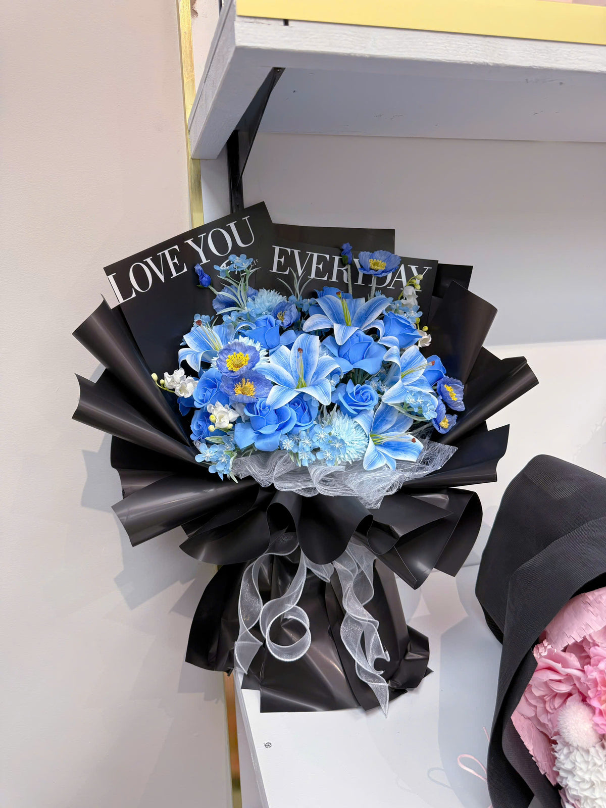 Blue flowers wrapped in black paper with a bold color combination