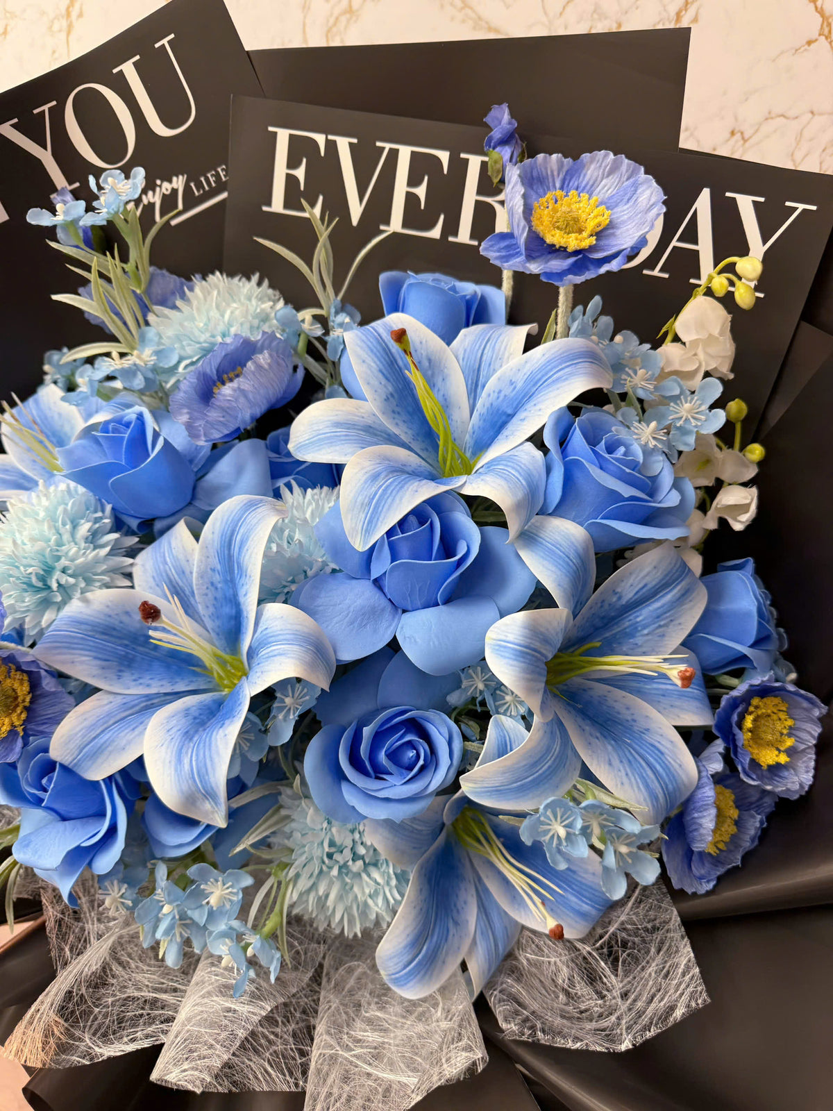 Blue flowers wrapped in black paper with a bold color combination
