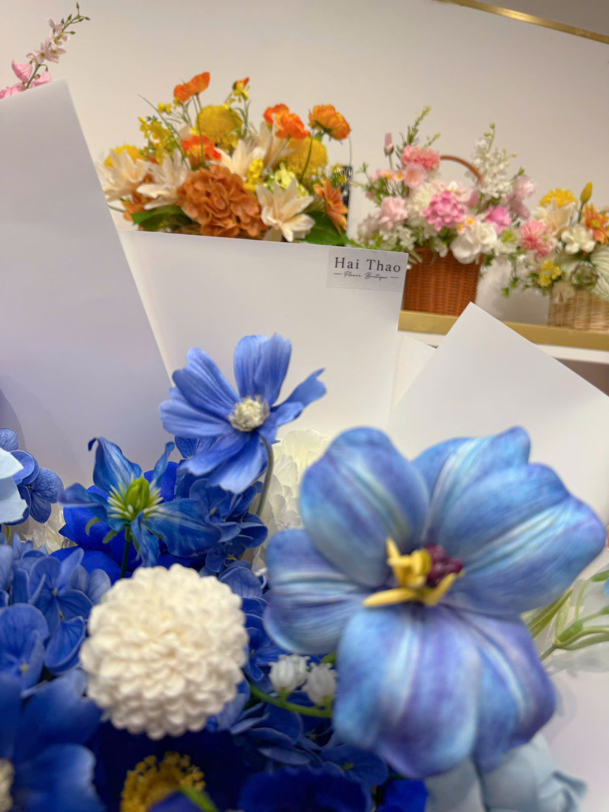 A blue-toned bouquet featuring a mix of different flowers
