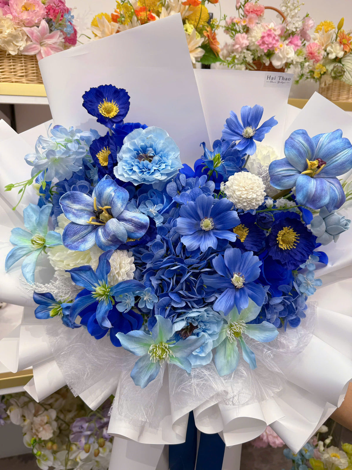 A blue-toned bouquet featuring a mix of different flowers