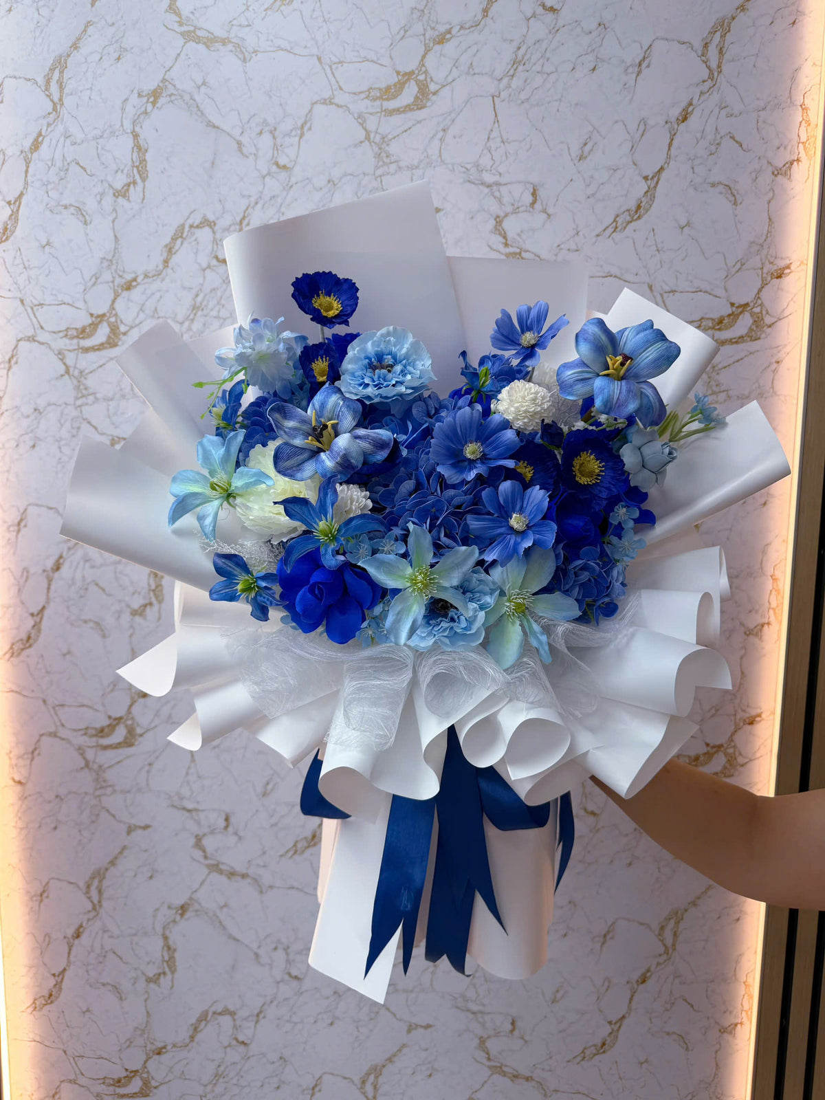 A blue-toned bouquet featuring a mix of different flowers