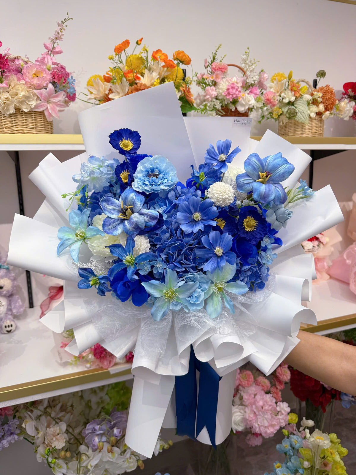 A blue-toned bouquet featuring a mix of different flowers
